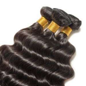 Bundles of shiny, wavy black hair extensions.