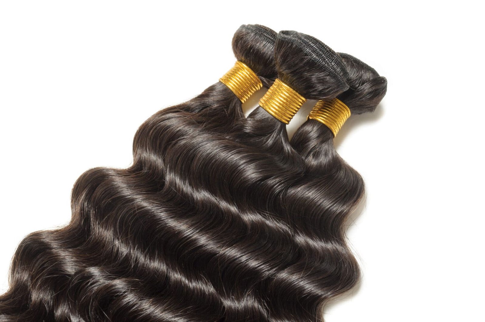 Bundles of shiny, wavy black hair extensions.