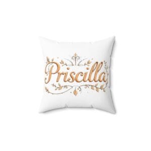 White pillow with golden text and decorative elements.