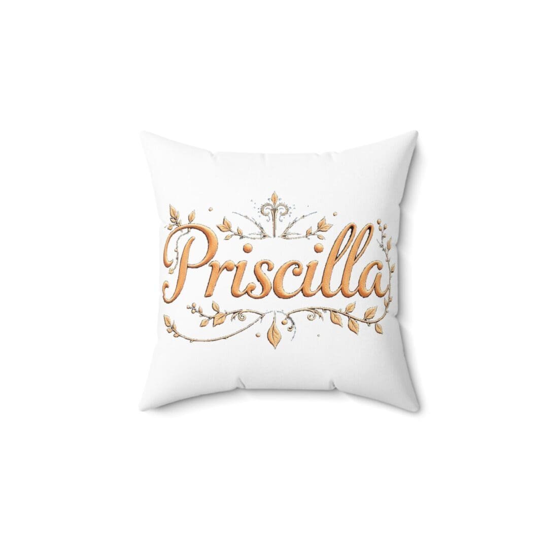 White pillow with golden text and decorative elements.