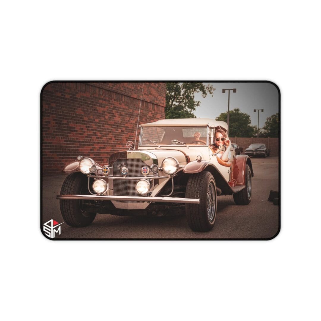 Vintage white car parked near a brick wall on a quiet street.