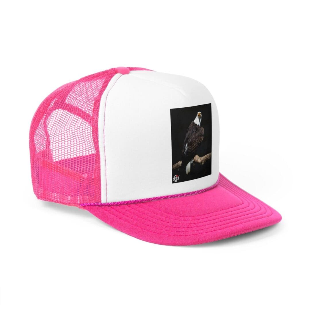 White and pink trucker hat with a black and white patch on front.