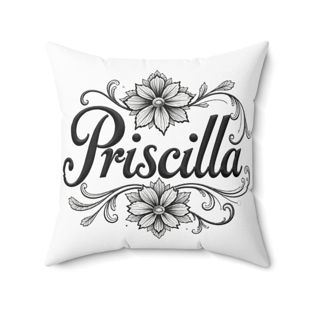 White pillow with the name Priscilla and floral designs.