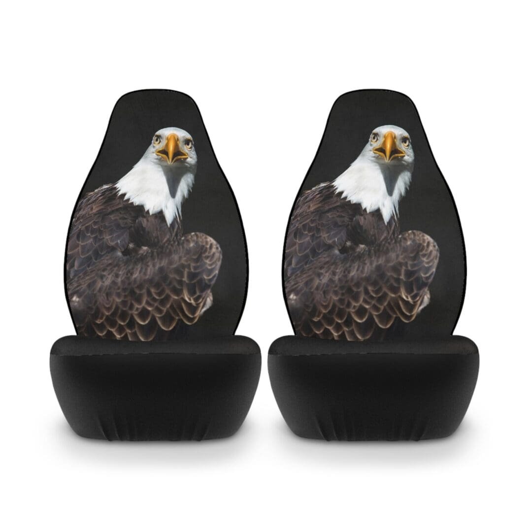 Two black car seat covers featuring a realistic bald eagle design.